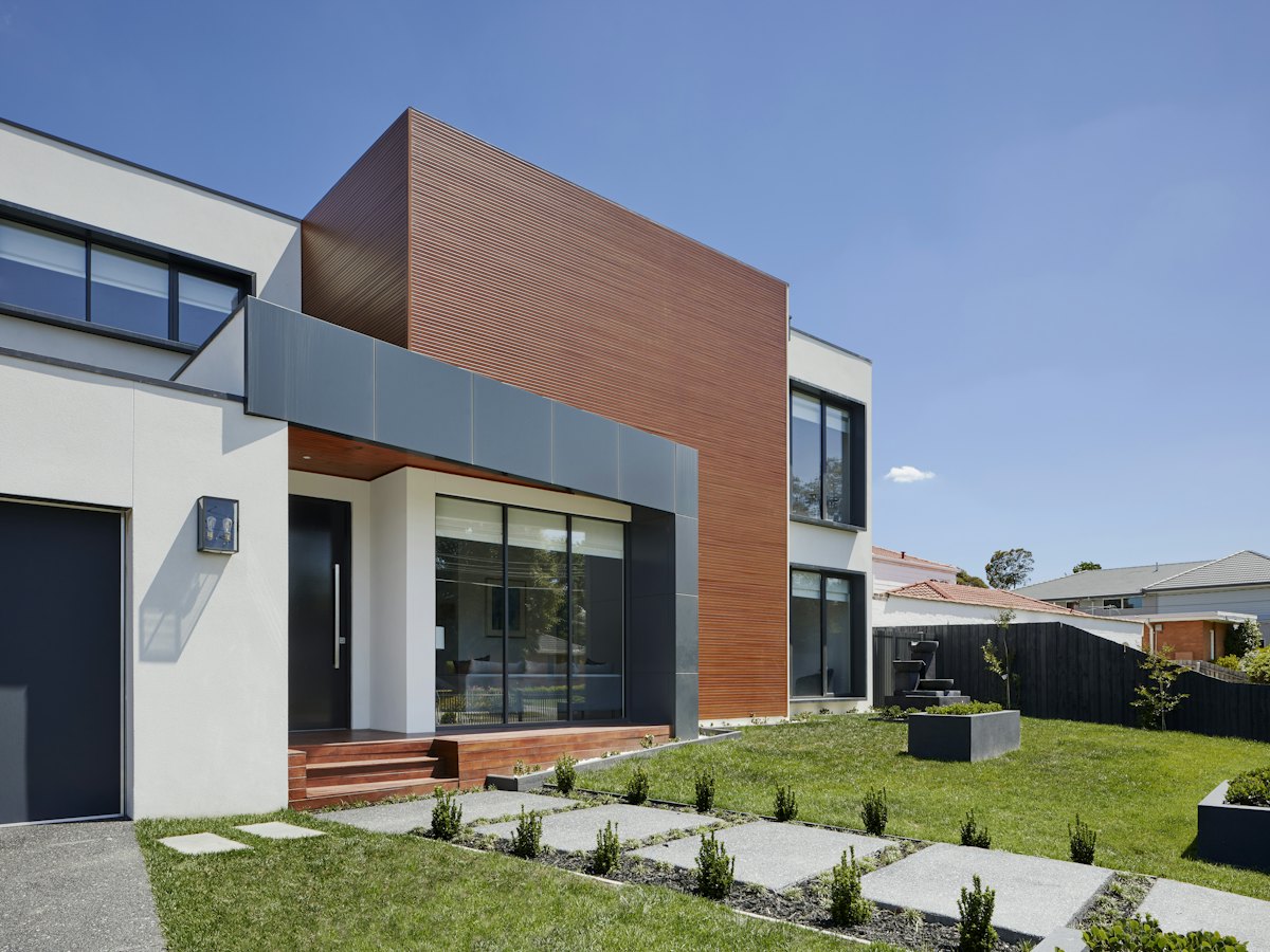Contemporary home with a grey and rust façade